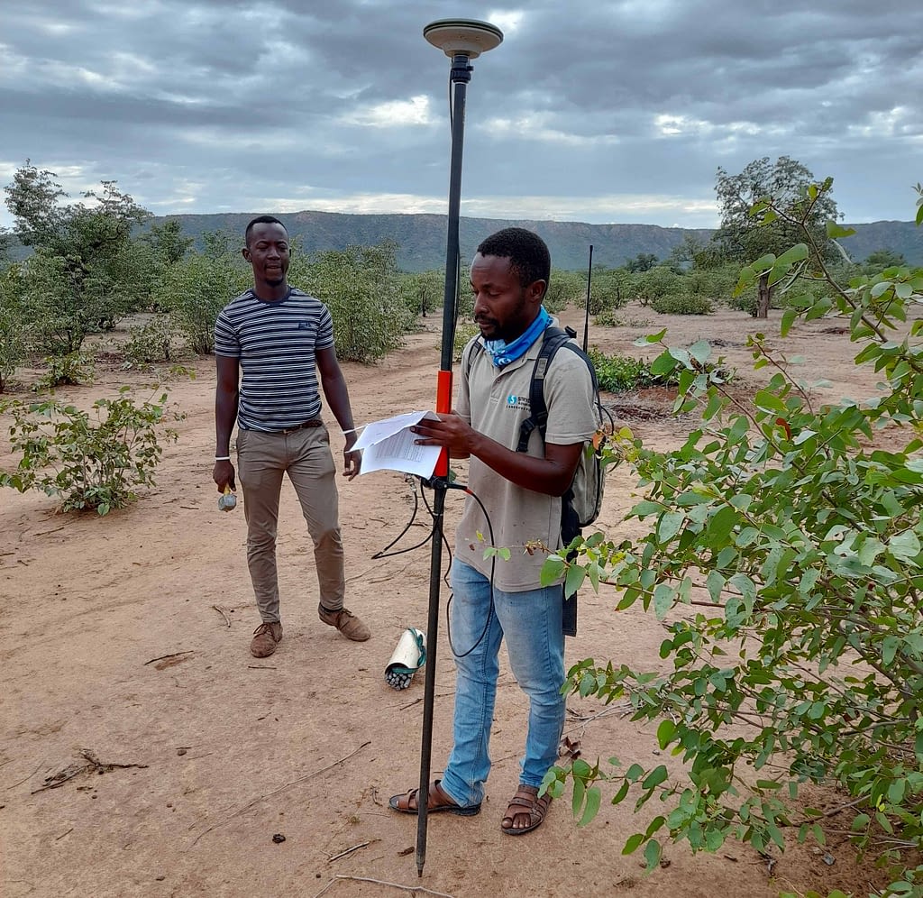 Two surveyors in the bush.