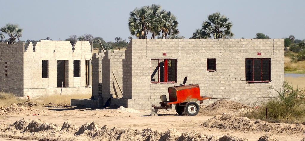 A partially constructed house made from grey bricks.