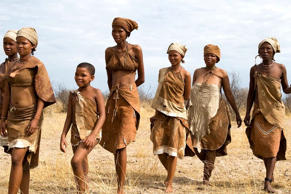 A group of seven happy looking San people.